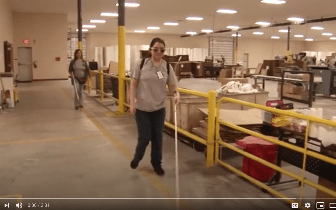 Employees navigate the production floor with white canes